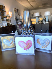 A captivating Heart Art masterpiece in pink and white hues, delicately crafted on paper. Encased in a luxurious 4 x 4 acrylic frame.